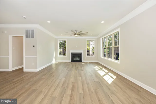 a kitchen with a sink cabinets and wooden floor