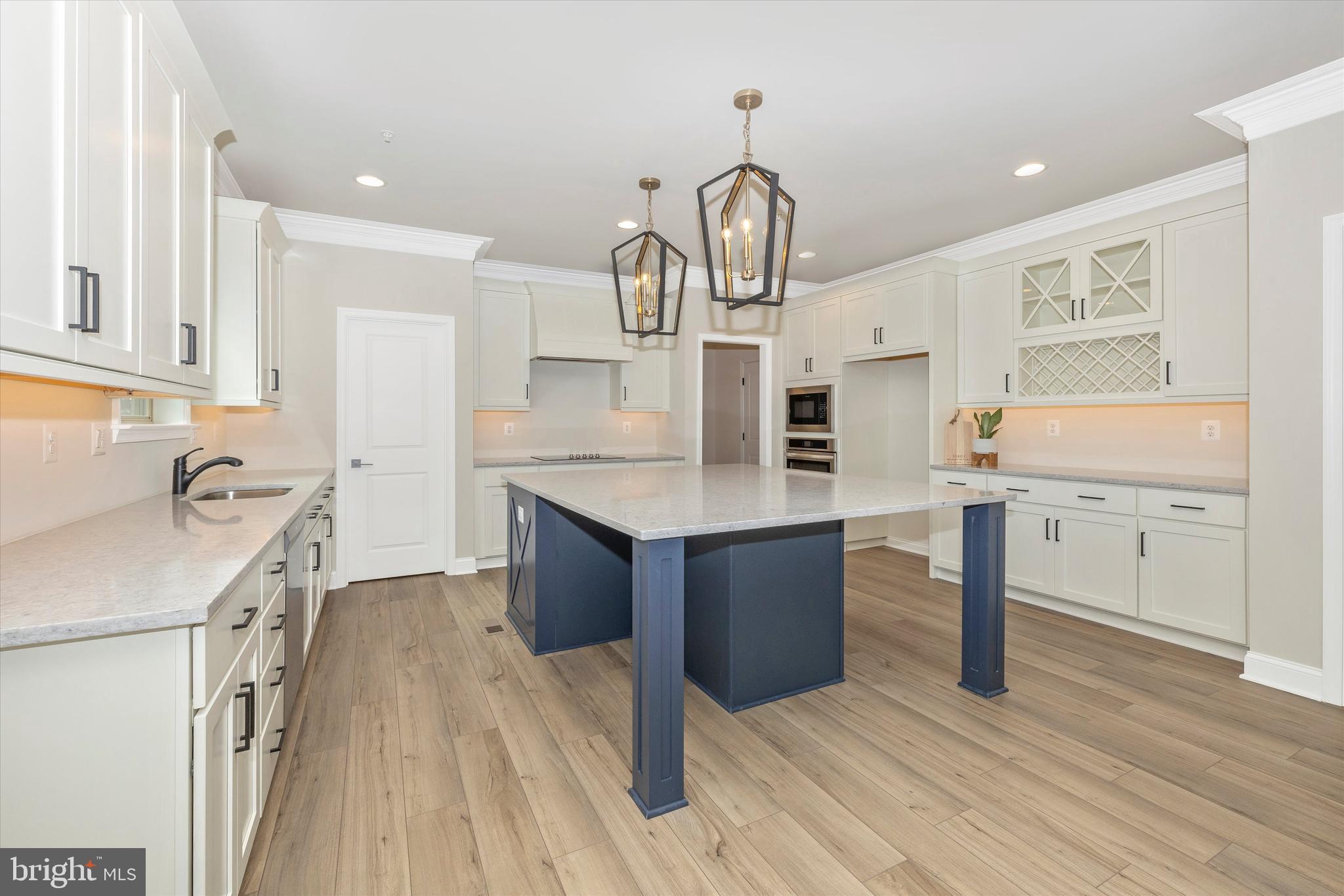 391 Masters Road New Market, MD 21774 - Photo 24 of 71 a kitchen with kitchen island granite countertop a sink appliances cabinets and wooden floor