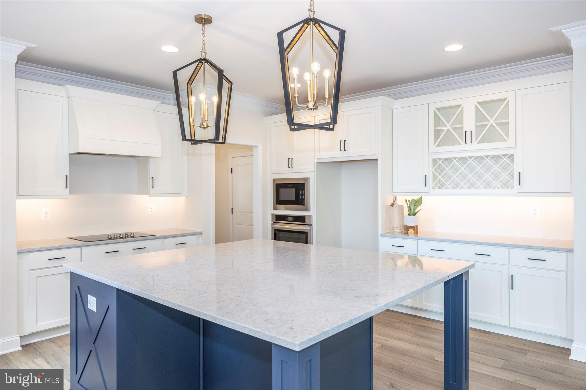 391 Masters Road New Market, MD 21774 - Photo 25 of 71 a kitchen with stainless steel appliances a table chairs in it and wooden floors