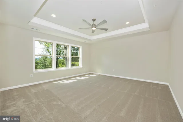 a view of a small space with wooden floor and a window