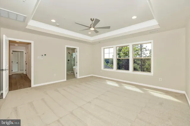 a view of a hallway with wooden floor and windows