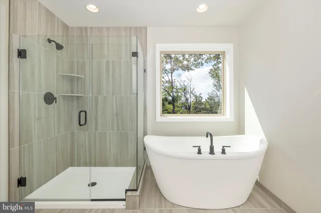 an empty room with a ceiling fan and a window