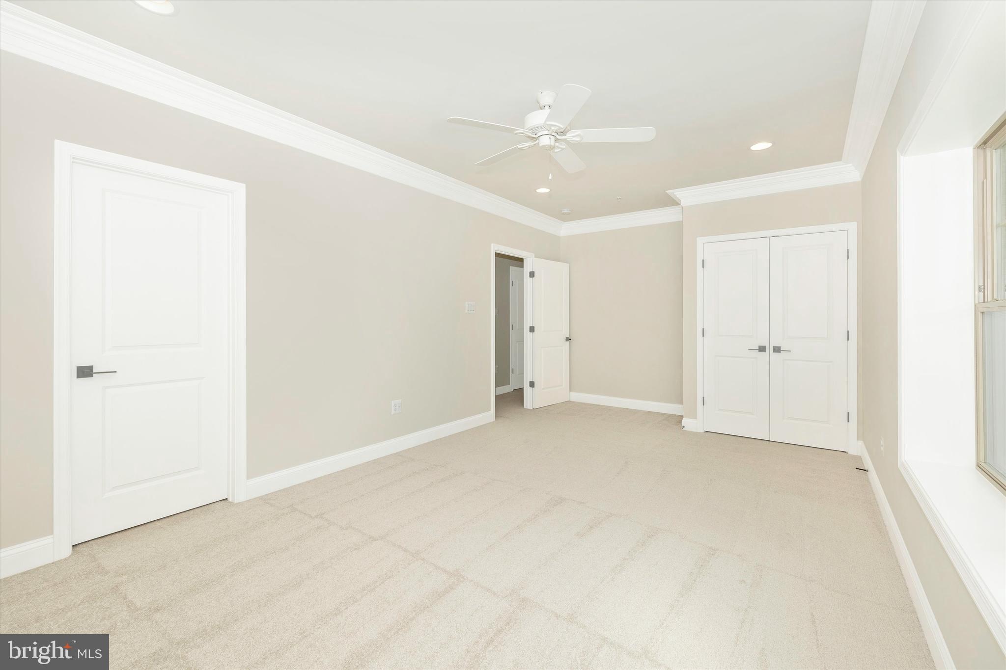 391 Masters Road New Market, MD 21774 - Photo 58 of 71 an empty room with a ceiling fan and a window