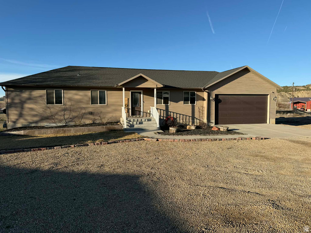 2095 West 4100 North Spring Glen, UT 84526 - Photo 1 of 35 Single story home with driveway, a porch, and an attached garage