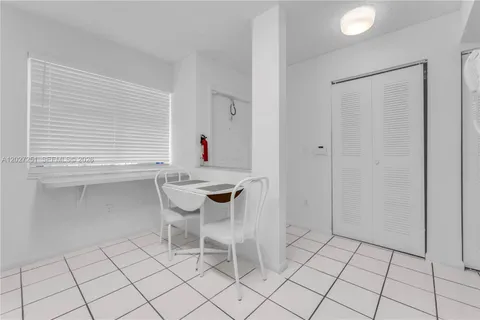 a view of a room that has a table and a chair in it