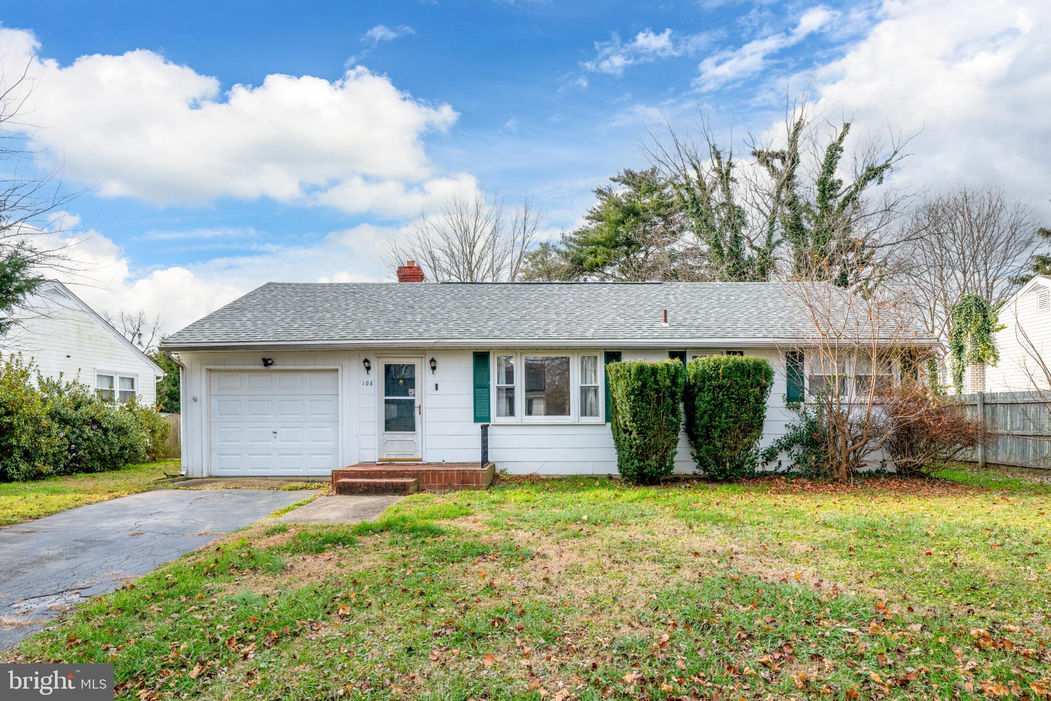 108 North Halsey Road Dover, DE 19901 - Photo 1 of 20 Charming home with lush greenery and sky.