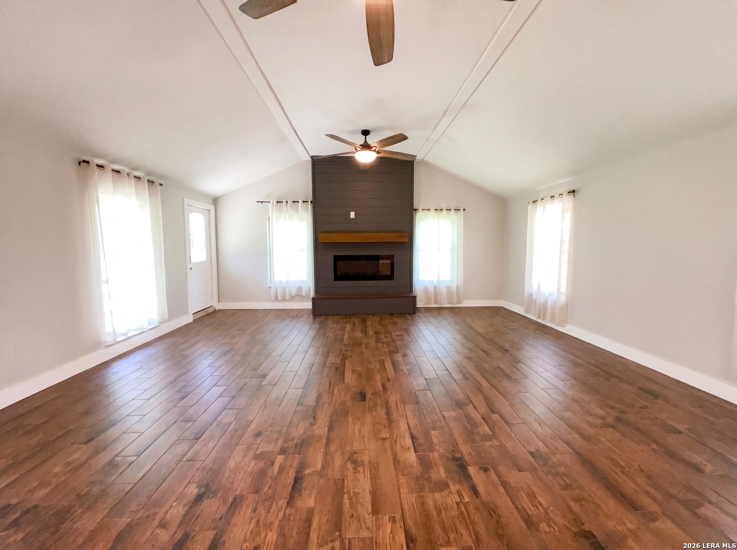 15422 Geronimo Loop San Antonio, TX 78254 - Photo 3 of 21 a view of a livingroom with wooden floor fireplace and window
