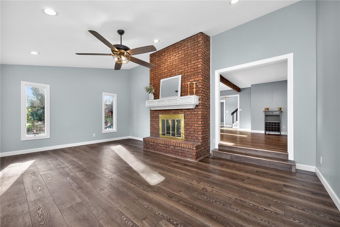 4747 Fawnwood Road Dayton, OH 45429 - Photo 18 of 58 This living room features a classic brick fireplace and elegant hardwood flooring.
