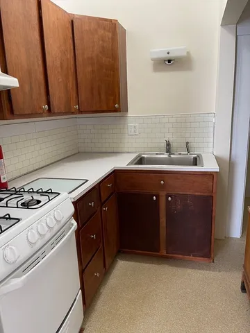 a kitchen with a sink stove and cabinets