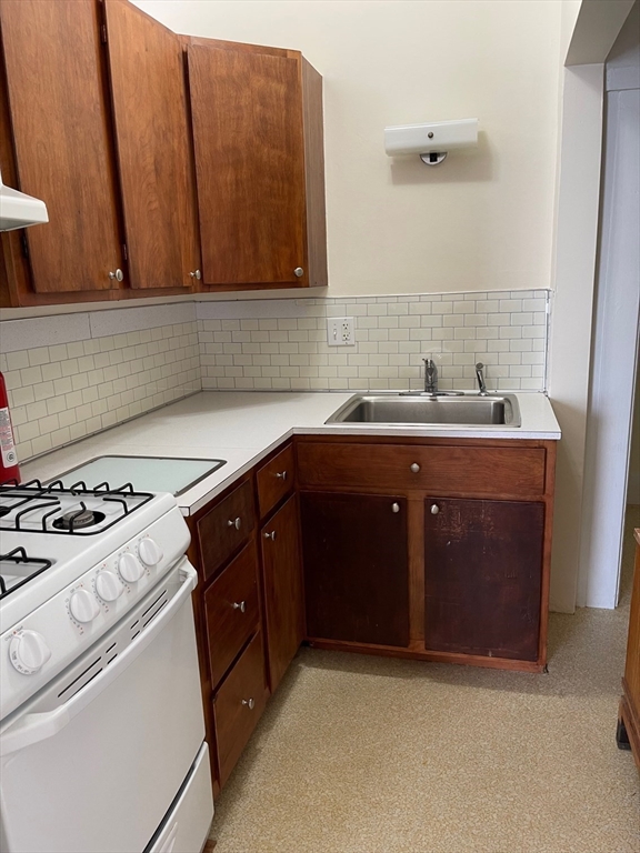 9 Windsor Avenue, Unit 9A Acton, MA 01720 - Photo 4 of 10 a kitchen with a sink stove and cabinets