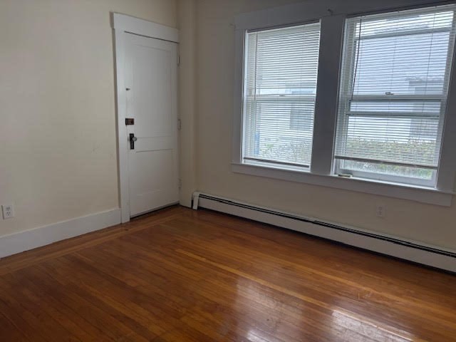 9 Windsor Avenue, Unit 9A Acton, MA 01720 - Photo 7 of 10 a view of an empty room with wooden floor and a window