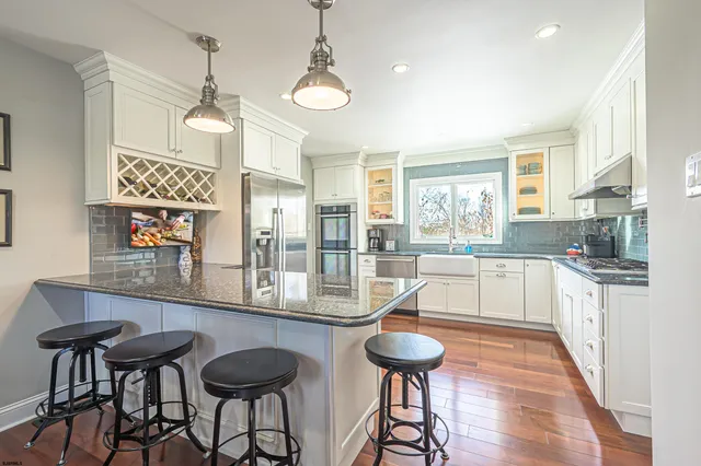a large kitchen with a table and chairs