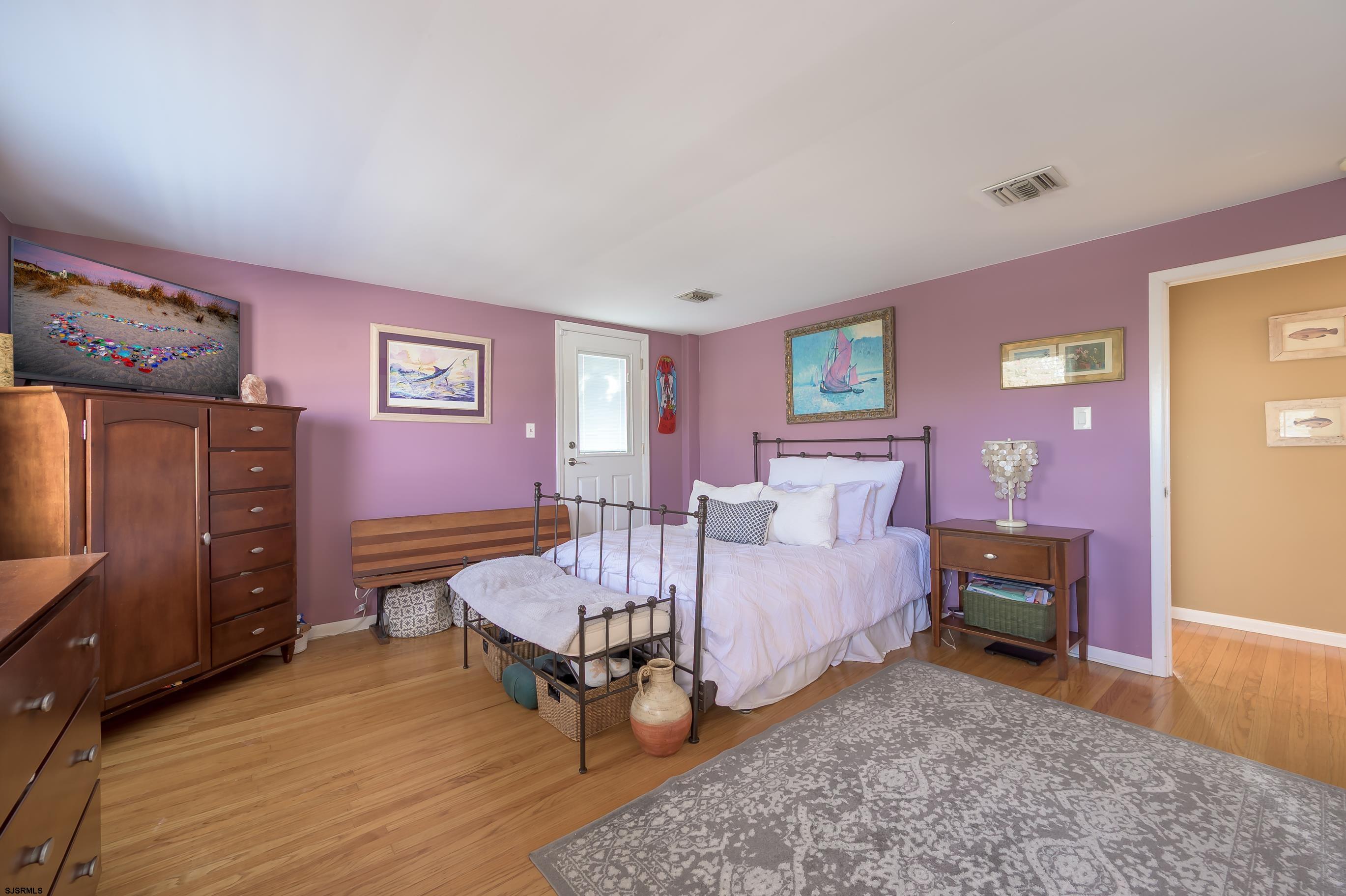 1 Exeter Court Margate City, NJ 08402 - Photo 6 of 25 a bedroom with a bed and wooden floor