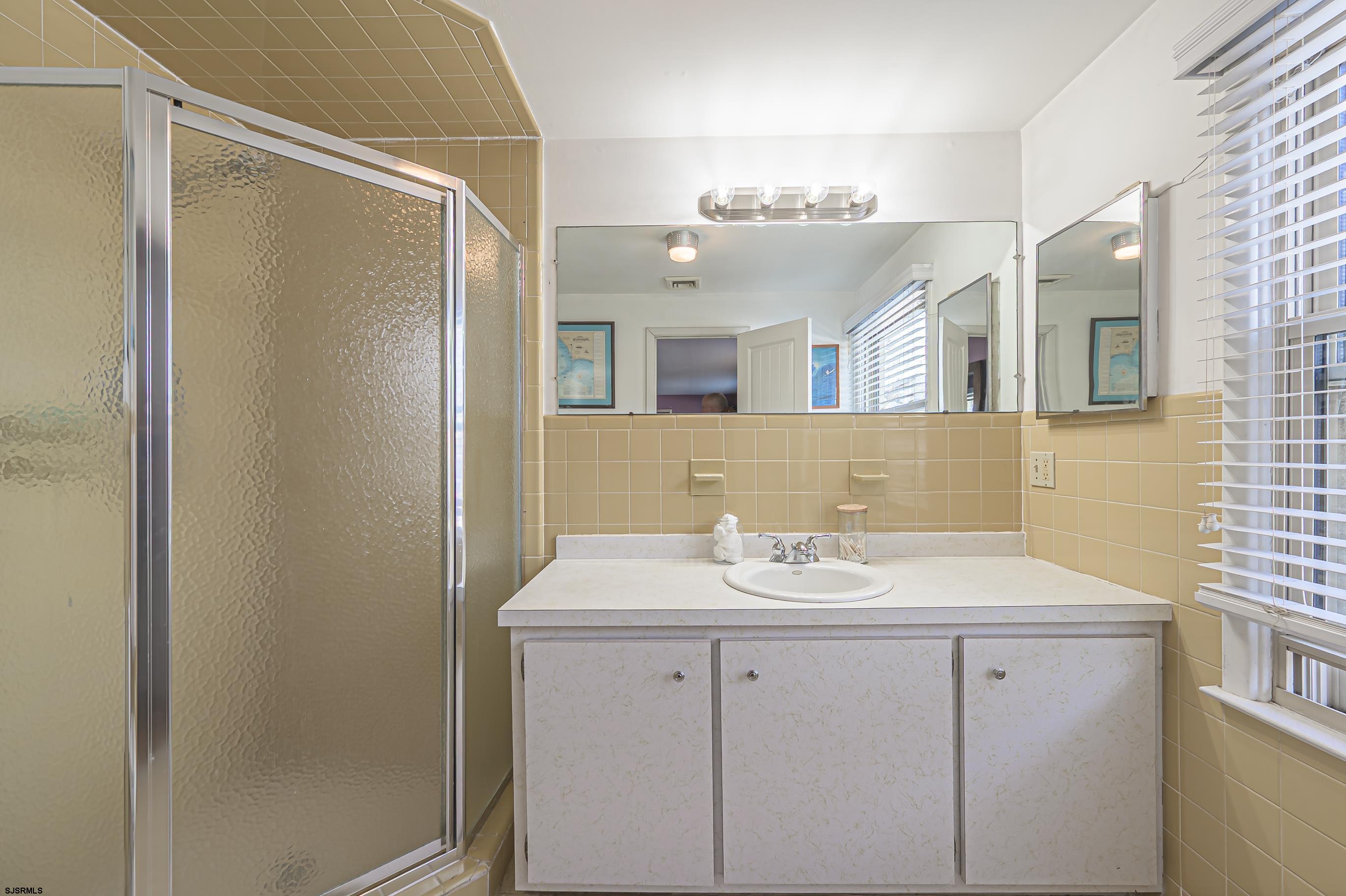 1 Exeter Court Margate City, NJ 08402 - Photo 8 of 25 a bathroom with a sink vanity and a mirror