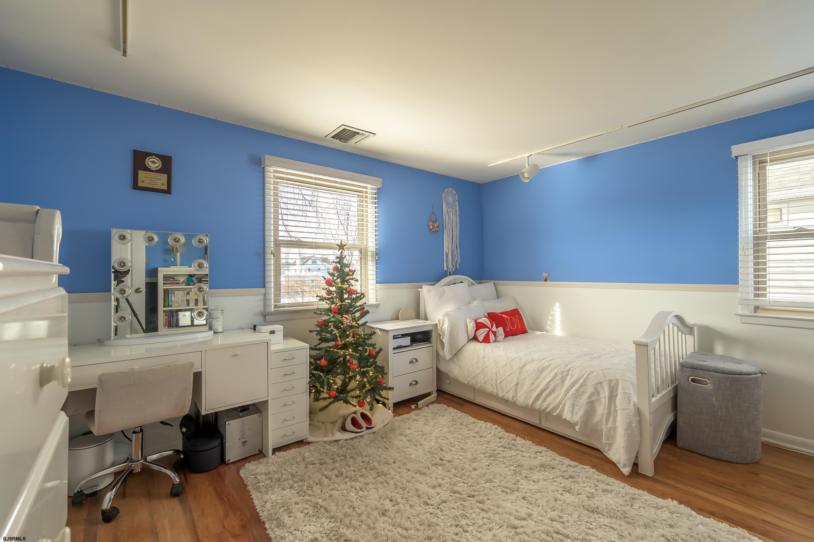 1 Exeter Court Margate City, NJ 08402 - Photo 9 of 25 a bedroom with a bed and a table in it