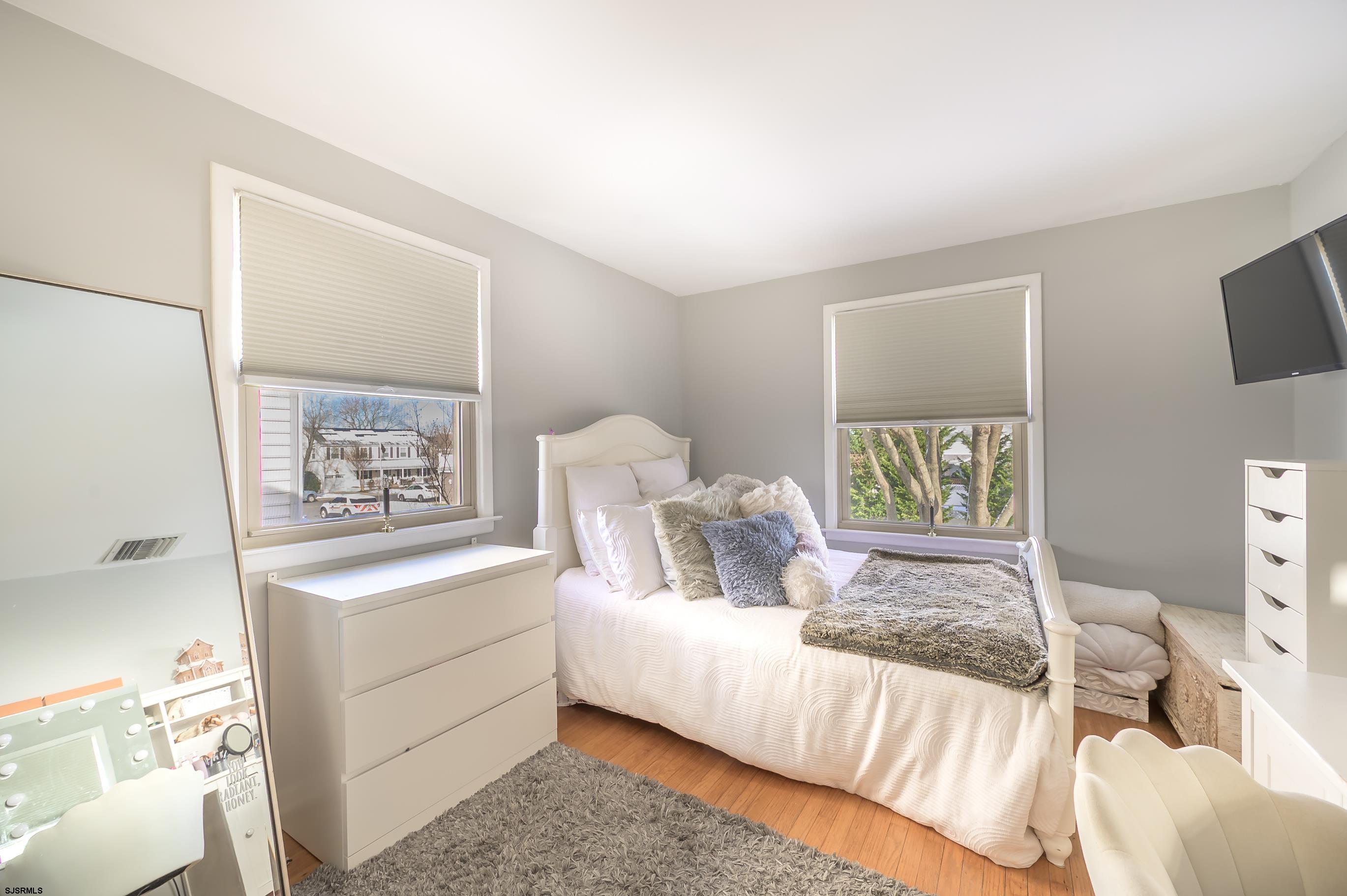 1 Exeter Court Margate City, NJ 08402 - Photo 10 of 25 a bedroom with a bed and a night stand