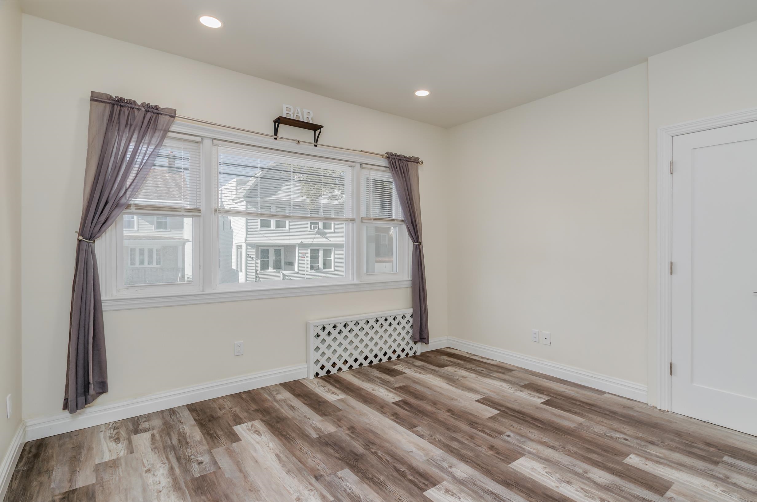 232 Pearsall Avenue, Unit 1 Jersey City, NJ 07305 - Photo 13 of 20 a view of an empty room with a window