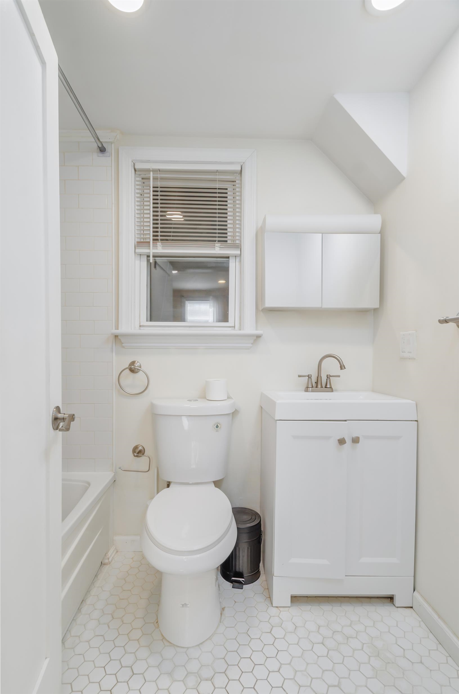 232 Pearsall Avenue, Unit 1 Jersey City, NJ 07305 - Photo 15 of 20 a white toilet sitting next to a bathroom sink