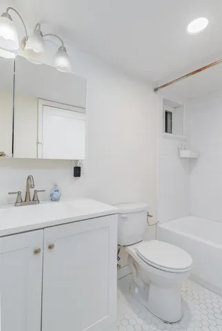 a white toilet sitting next to a bathroom sink