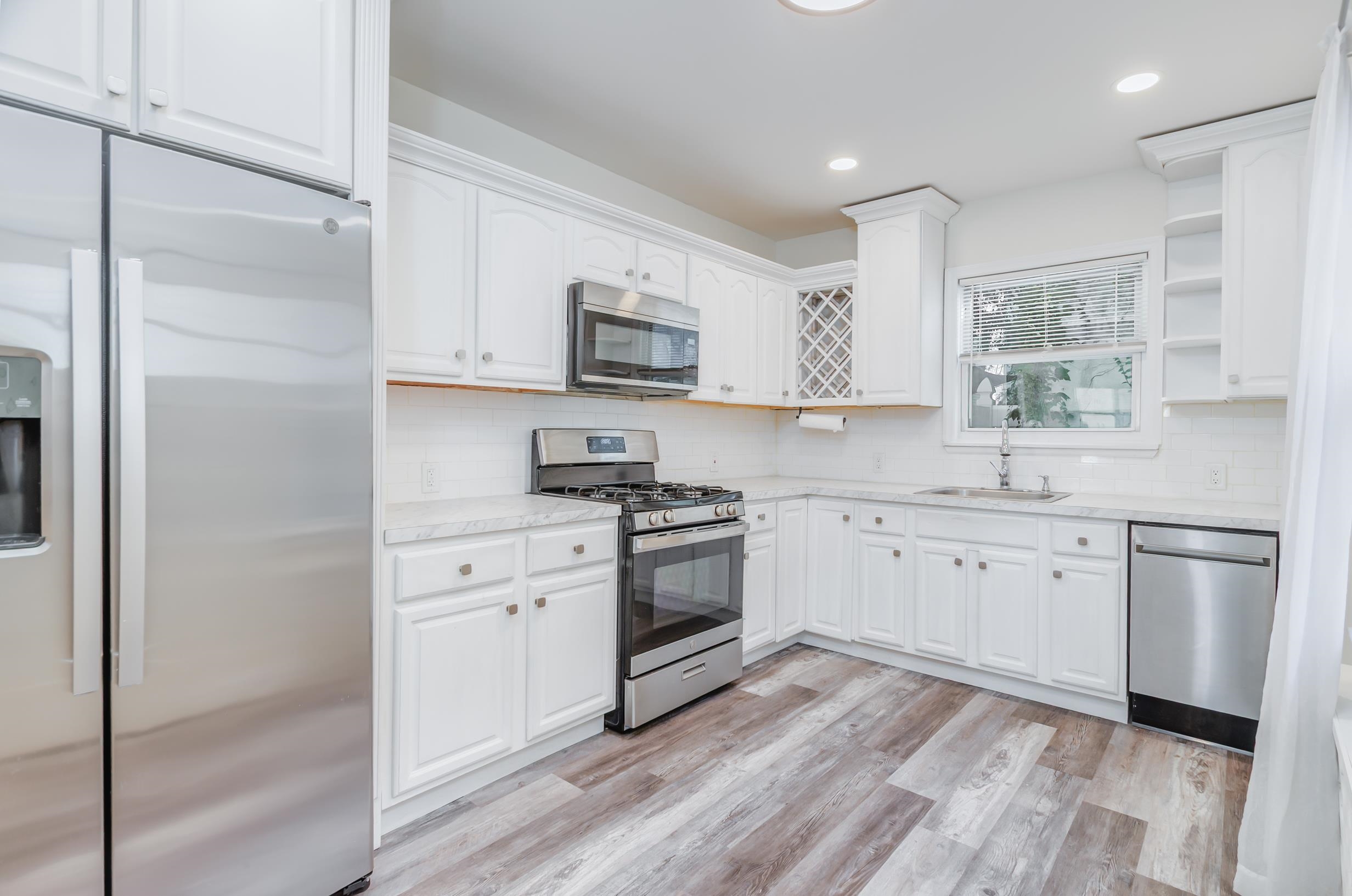 232 Pearsall Avenue, Unit 1 Jersey City, NJ 07305 - Photo 5 of 20 a kitchen with stainless steel appliances a stove a sink and a refrigerator