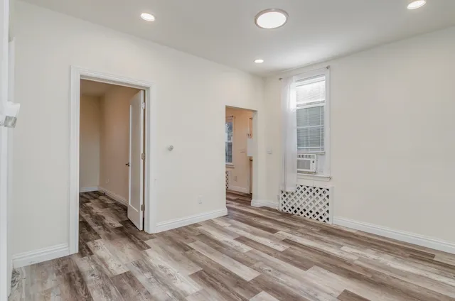 a view of a livingroom with wooden floor and closet