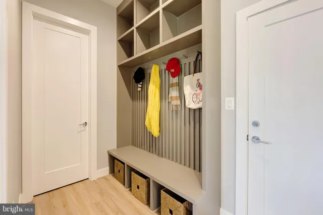 a view of a hallway with wooden floor and entryway