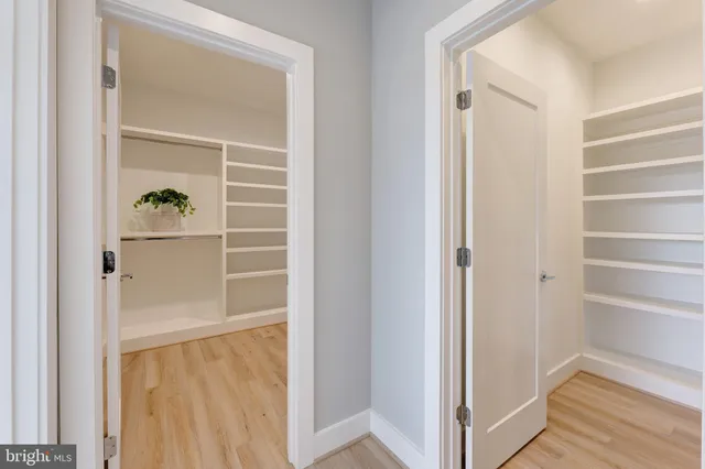 a view of walk in closet with empty racks