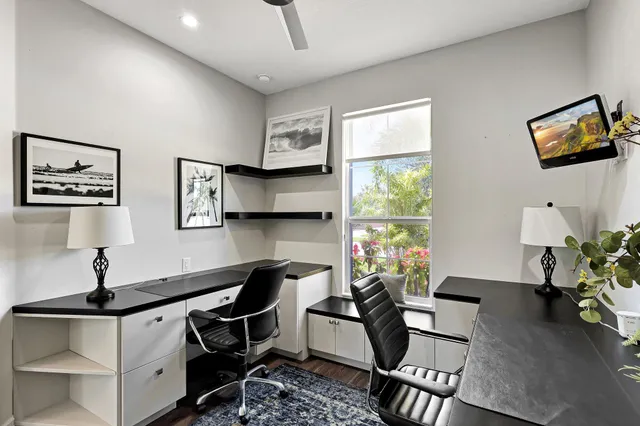 a living room with furniture a window and a flat screen tv