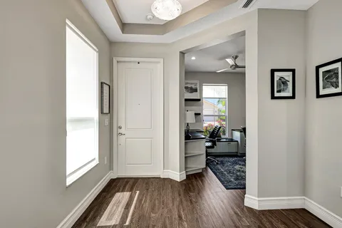 a view of a hallway and a livingroom with furniture