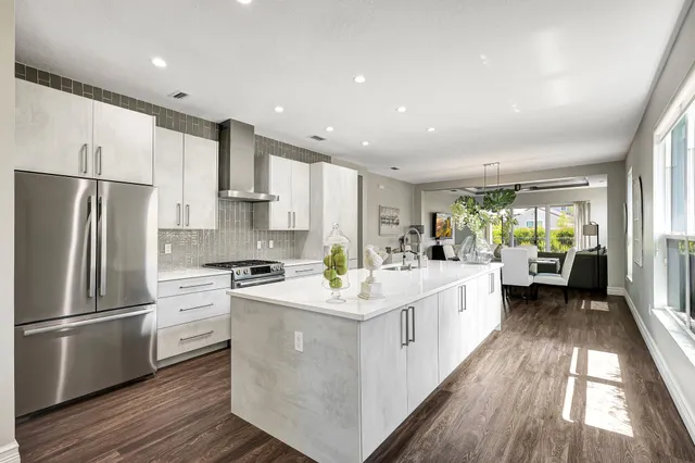 a kitchen with white cabinets and stainless steel appliances