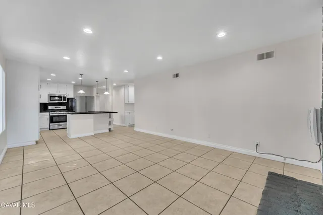 a view of kitchen with white cabinets