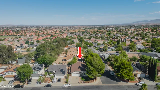 an aerial view of house with yard and seating space