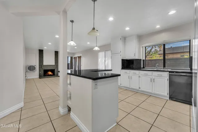 a kitchen with stainless steel appliances kitchen island granite countertop a sink and cabinets