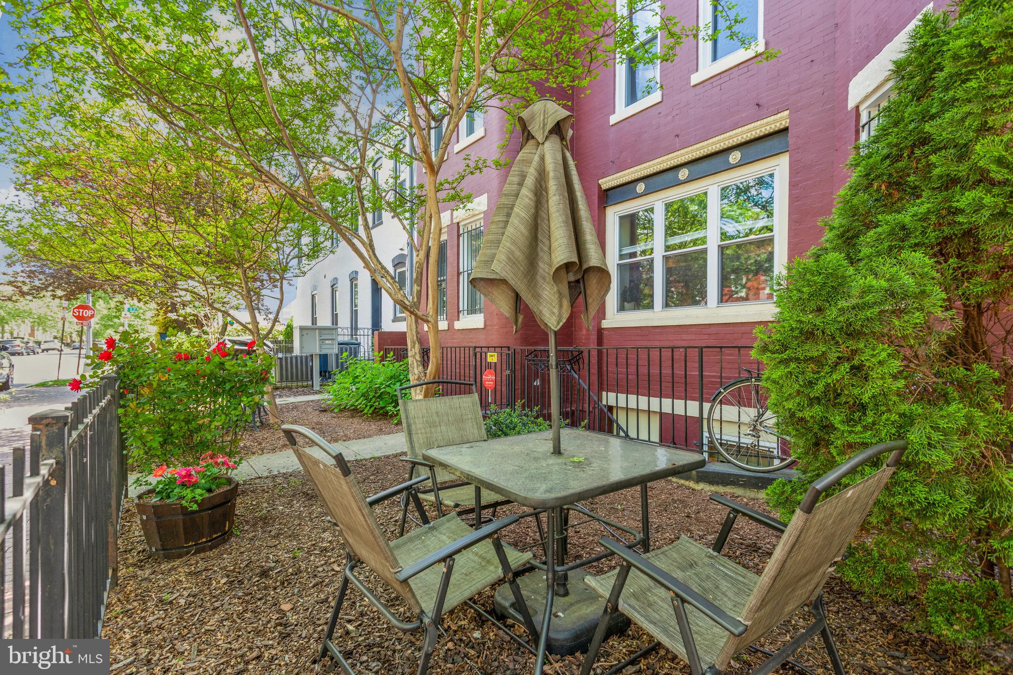 a view of a chairs and table in backyard of the house