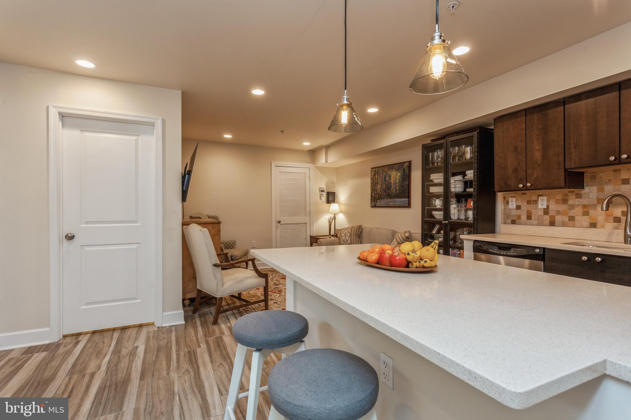 304 Q Street Northwest, Unit 1 Washington, DC 20001 - Photo 35 of 36 a kitchen with stainless steel appliances granite countertop a sink and a refrigerator