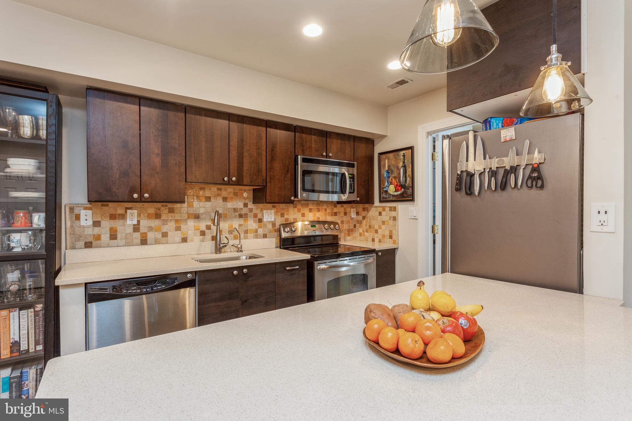 304 Q Street Northwest, Unit 1 Washington, DC 20001 - Photo 2 of 36 a kitchen with stainless steel appliances granite countertop a stove refrigerator and cabinets