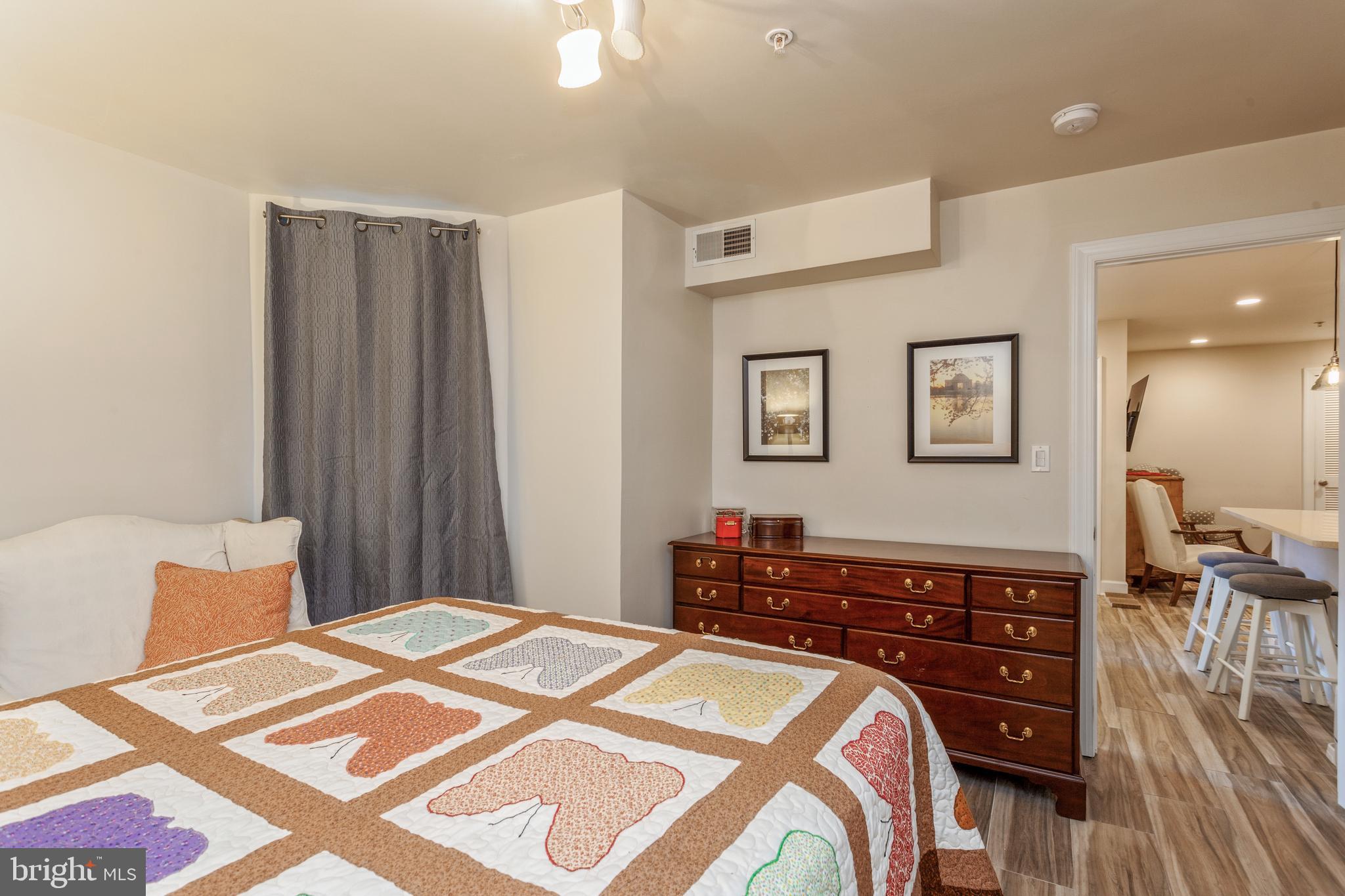 304 Q Street Northwest, Unit 1 Washington, DC 20001 - Photo 22 of 36 a bedroom with a bed and wooden floor