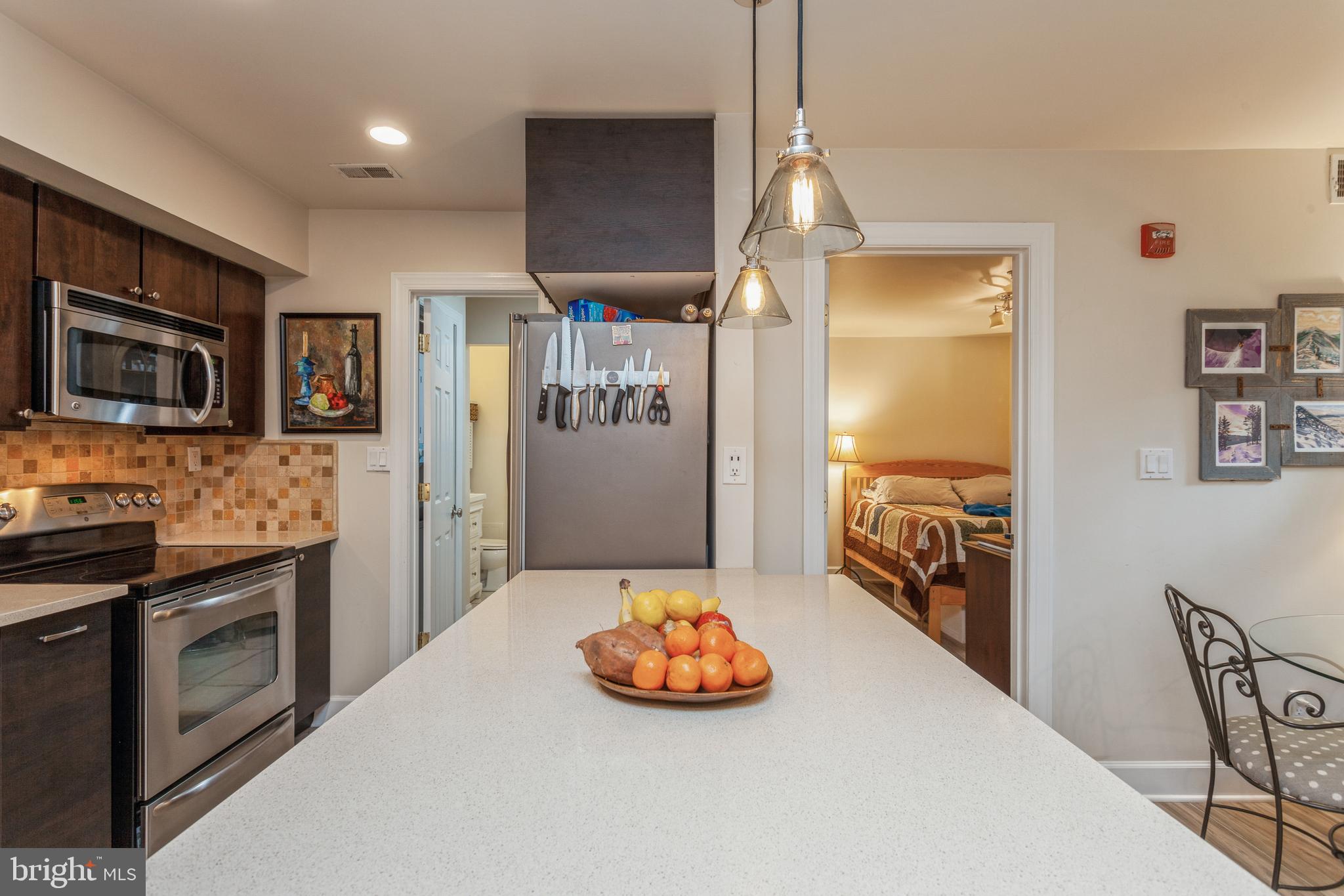 304 Q Street Northwest, Unit 1 Washington, DC 20001 - Photo 6 of 36 a kitchen with stainless steel appliances a refrigerator and a stove top oven