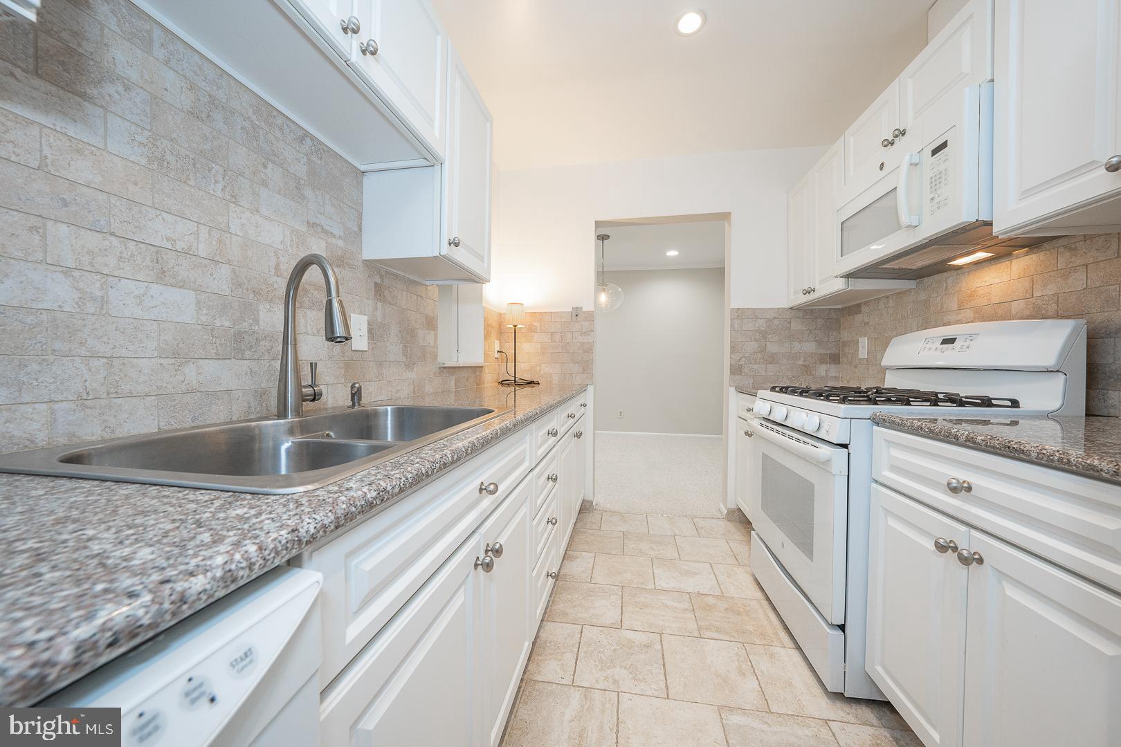 446 Drummers Lane Wayne, PA 19087 - Photo 15 of 29 a kitchen with granite countertop a sink and cabinets