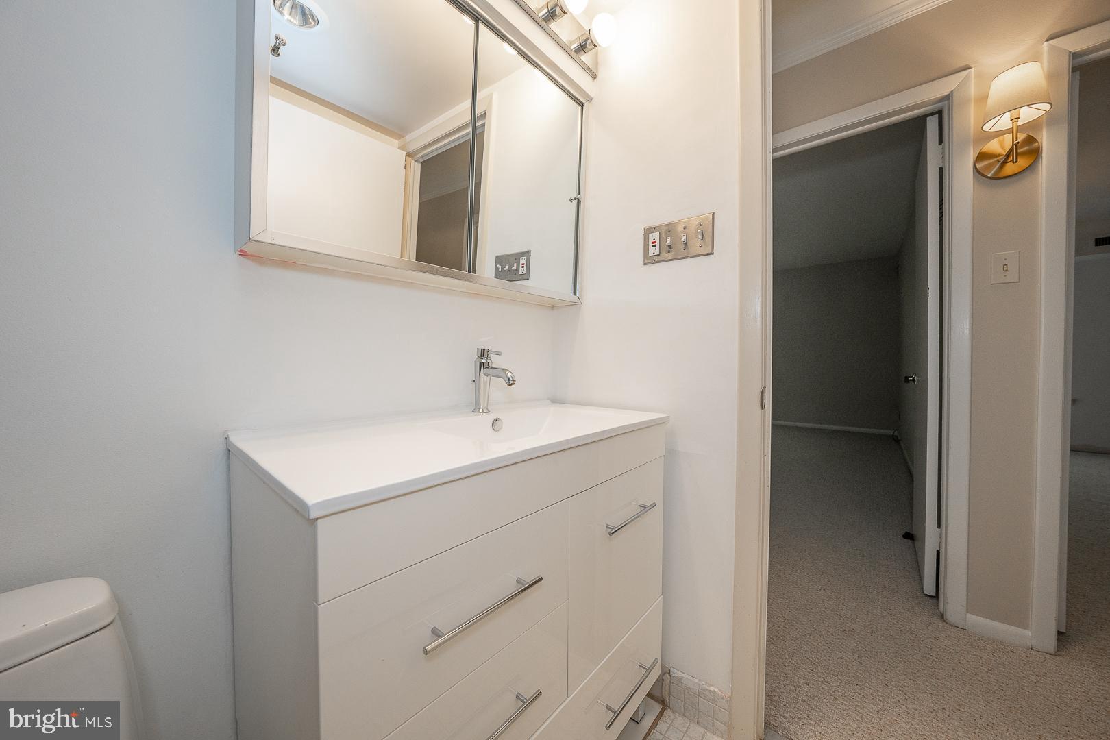 446 Drummers Lane Wayne, PA 19087 - Photo 25 of 29 a bathroom with a sink a toilet and mirror