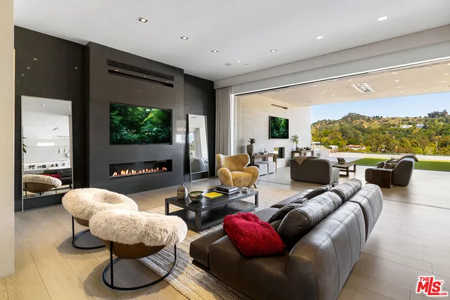 a living room with furniture and a floor to ceiling window