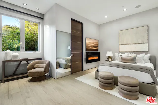 a bedroom with a large bed and a window