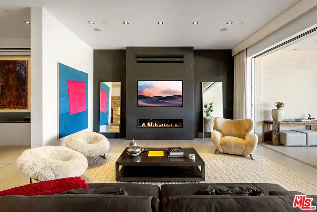 a living room with furniture ceiling fan and a window
