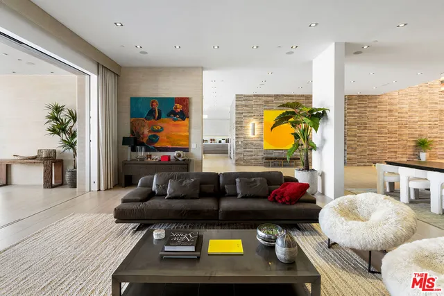 a living room with furniture and potted plant