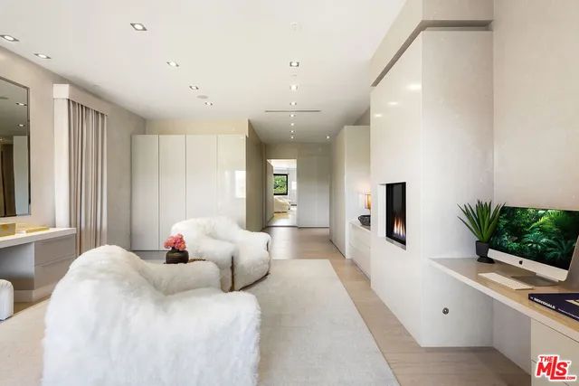 a living room with a large window and furniture