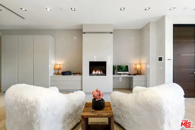 a view of a room with a large window and wooden floor