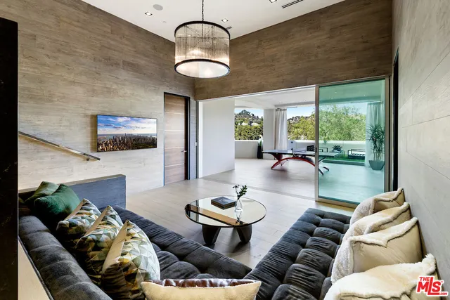 a bedroom with furniture and a large window