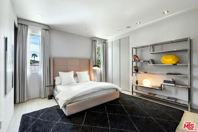 a view of a swimming pool with a table and chairs a fire pit