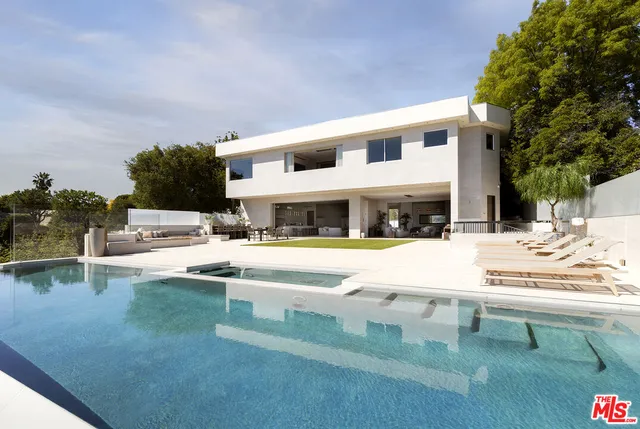 a living room with furniture a chandelier and a pool table