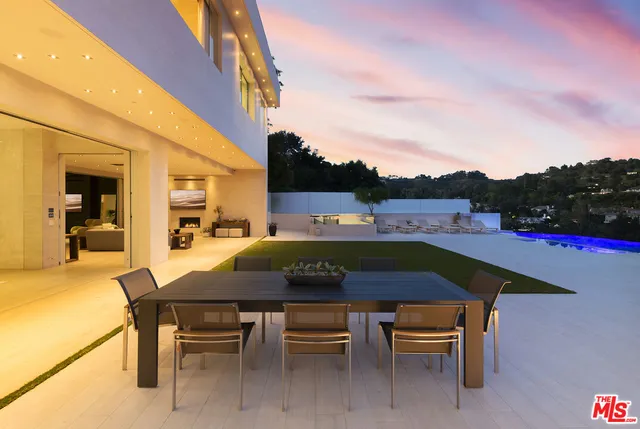 a view of an empty room with a fireplace and a tree